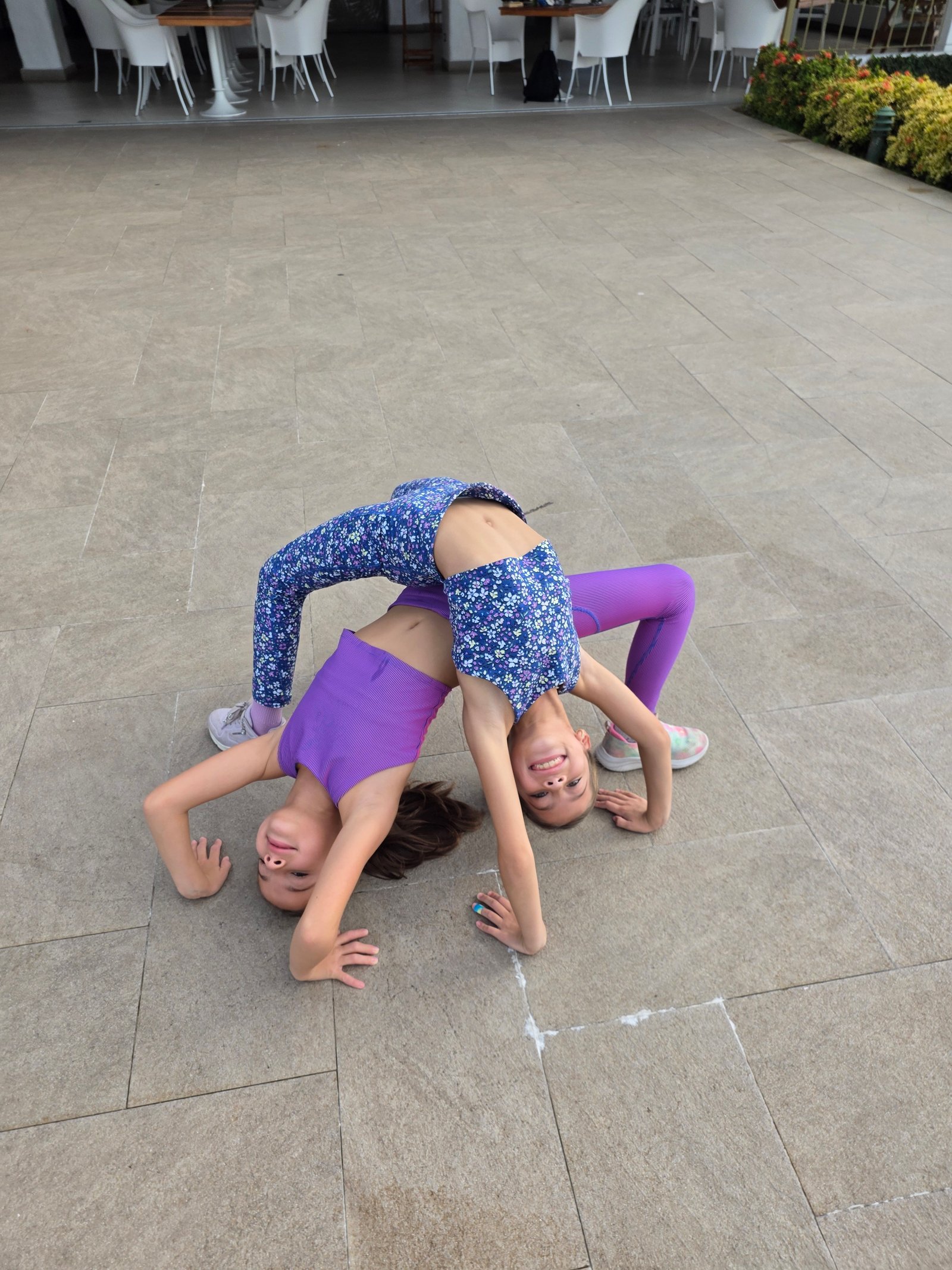 Both girls doing acrobatic backbend at Costa Rica resort