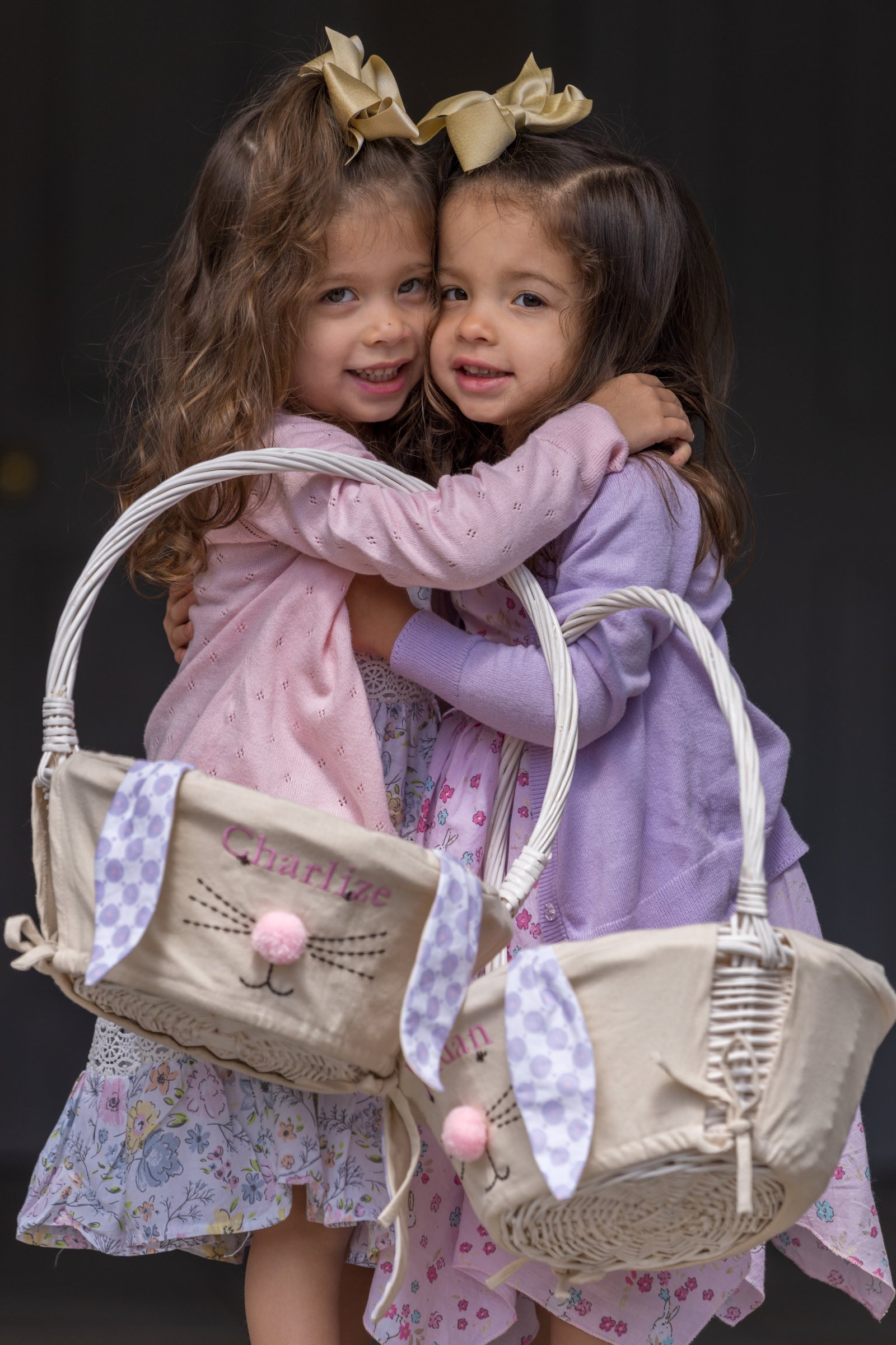 Charlize and JoJo hugging with Easter baskets in a professional portrait