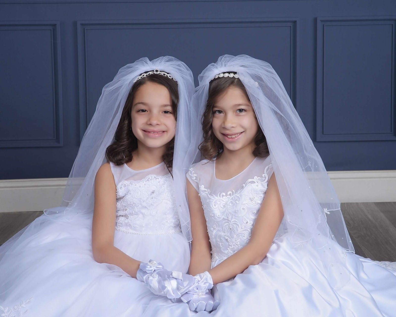 Charlie and JoJo in white First Holy Communion gowns in March 2025