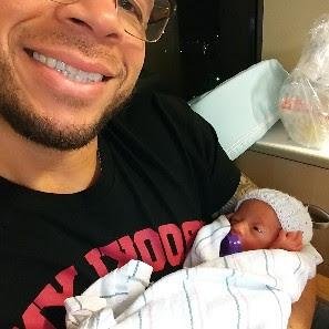 Bobby holding one of his daughters in the NICU